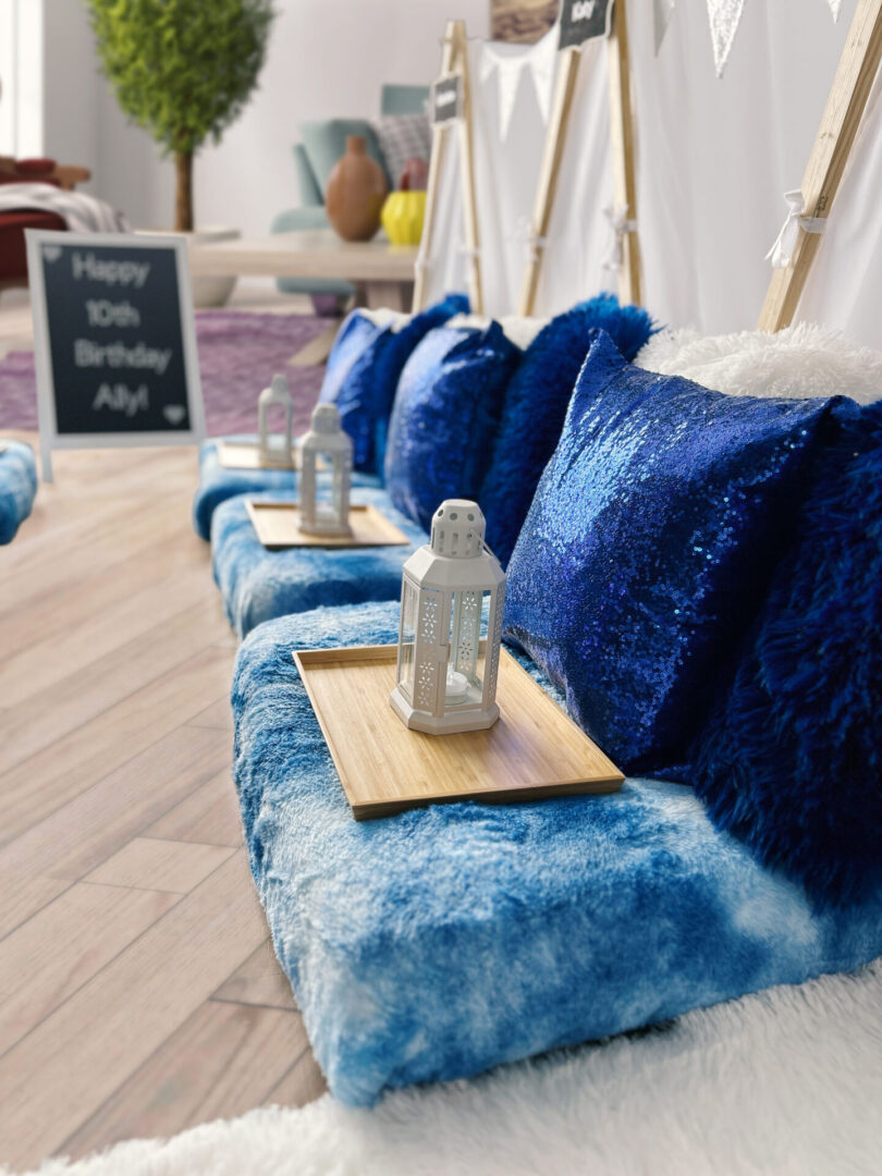 A row of blue pillows on top of a wooden floor.