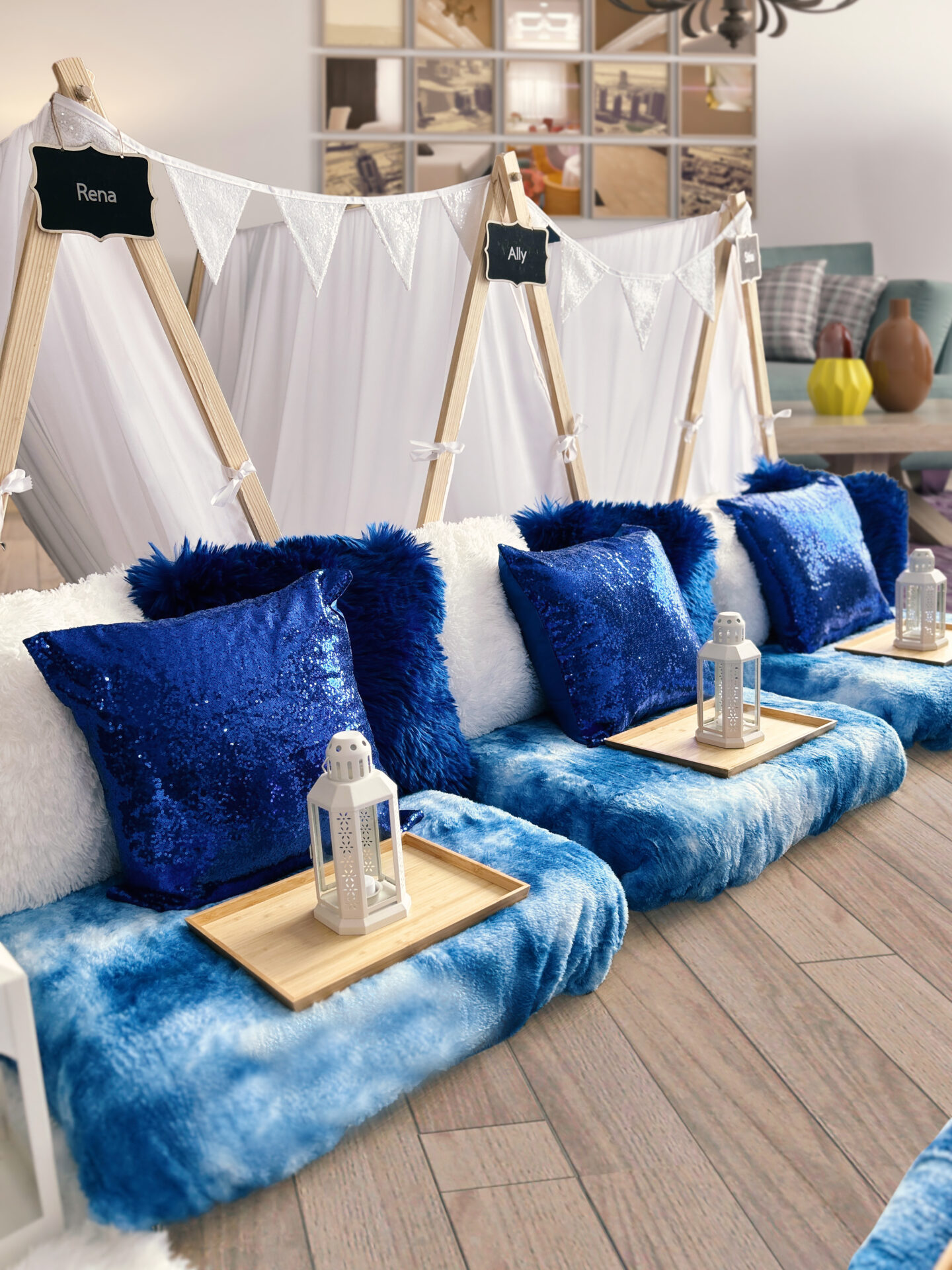 A row of blue pillows on top of white cushions.