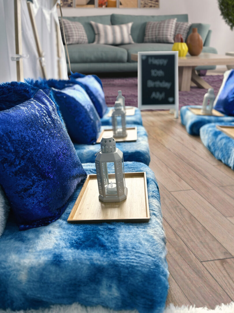 A room with blue furniture and wooden floors.