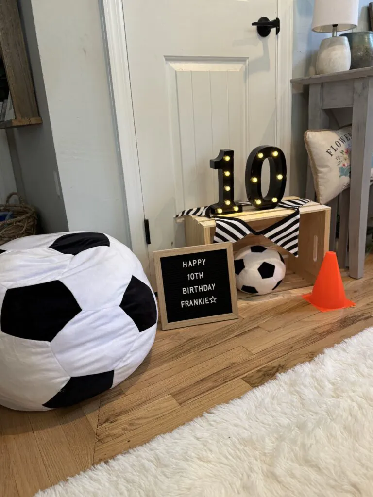 Wooden crate prop styled with soccer-themed decorations, including mini soccer balls and sporty accents, perfect for a boys’ soccer slumber party.