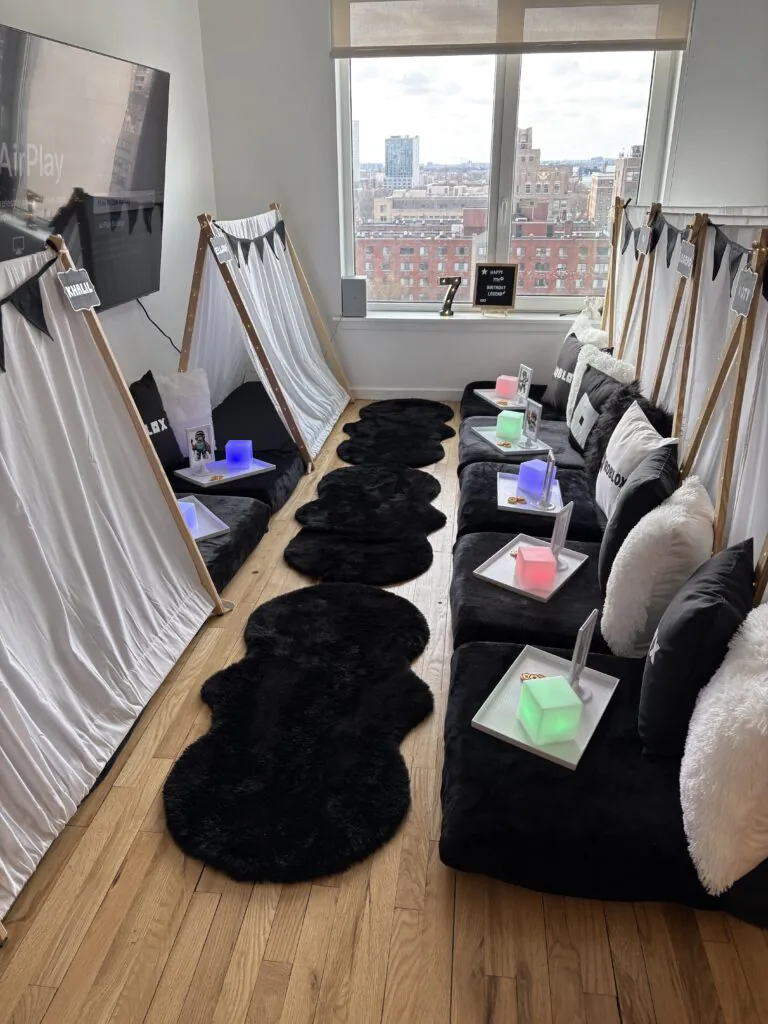 Custom Roblox sleepover party with teepee tents, styled bedding, marquee letters, and Roblox-themed accessories for a boys birthday slumber party.