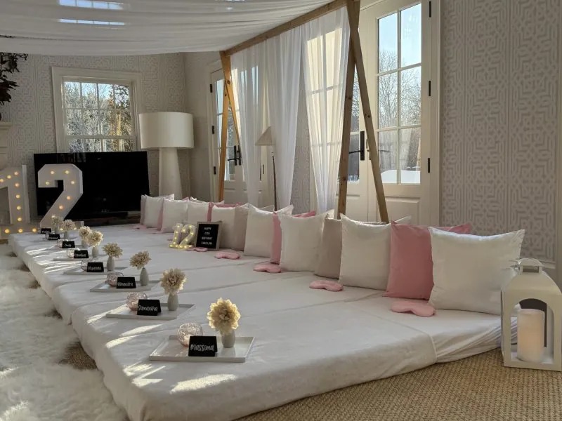 Canopy slumber party tent setup with decorated beds, themed pillows, and cozy sleepover styling by Up Parties